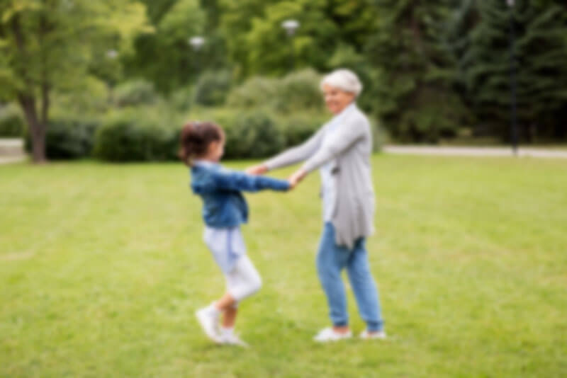 Older Woman Playing With Her Granddaughter - Blurry