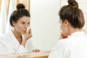 girl applying makeup remover