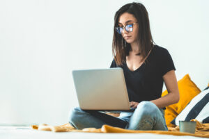 girl using computer glasses while using laptop