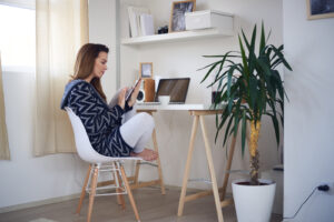 girl sitting at desk using phone 