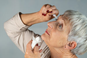 woman using eye drops 