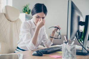 woman eyes straining from looking at computer 