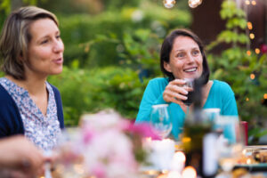 woman having glass of wine at dinner