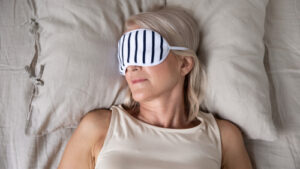 woman in bed with sleep mask on 