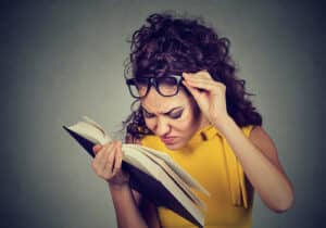 Woman with glasses reading book